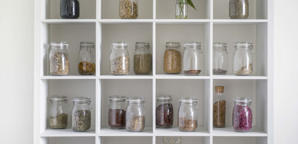 jars of healthy herbs on a shelf
